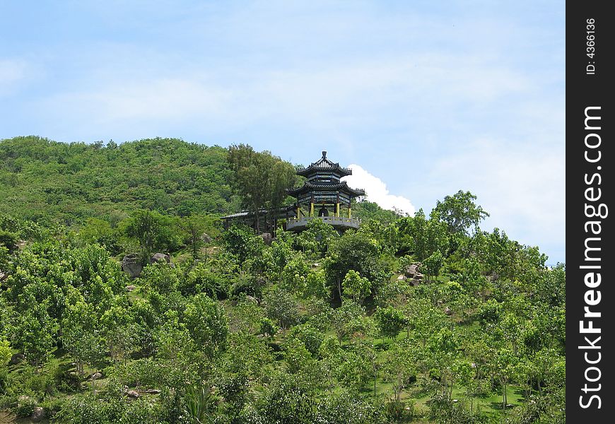 Chinese summerhouse on flank of hill in the park Nanshan on Hainan, China.