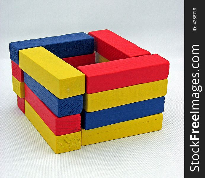 Coloured blocks for children stacked up to form a square.
