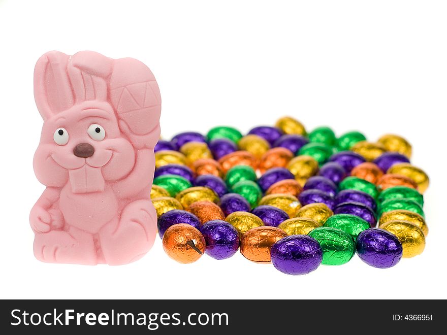Cute easter bunny surrounded by easter eggs isolated on a white background