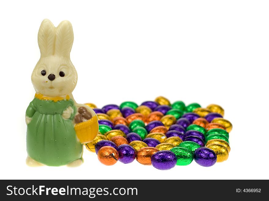 Cute easter bunny surrounded by easter eggs isolated on a white background