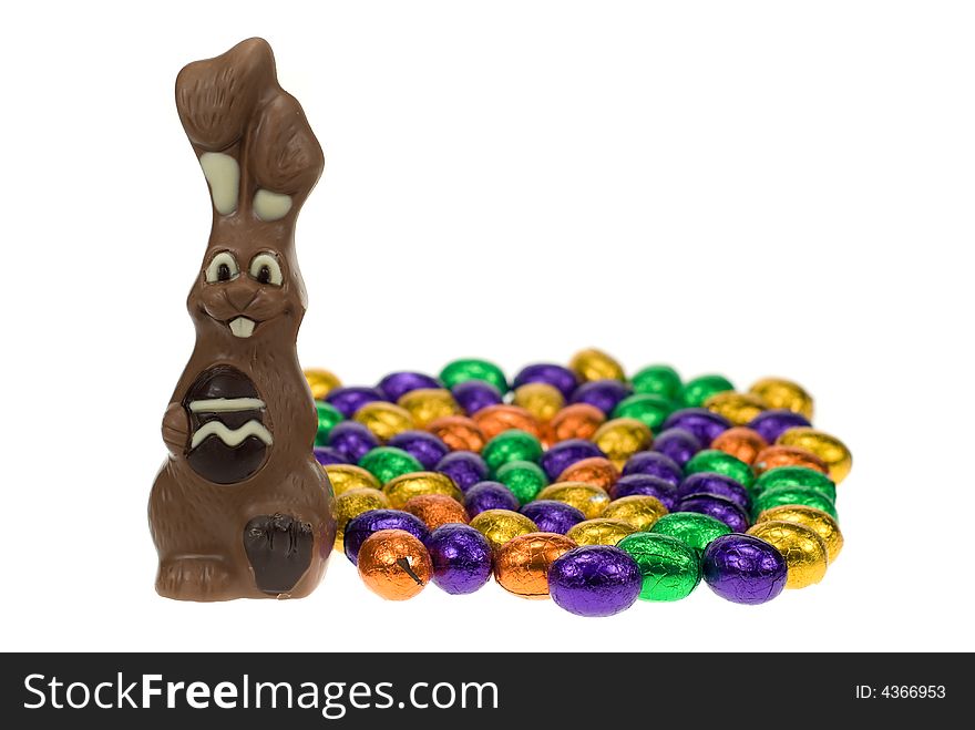 Cute easter bunny surrounded by easter eggs isolated on a white background