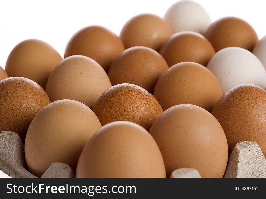 Brown and white eggs in a box