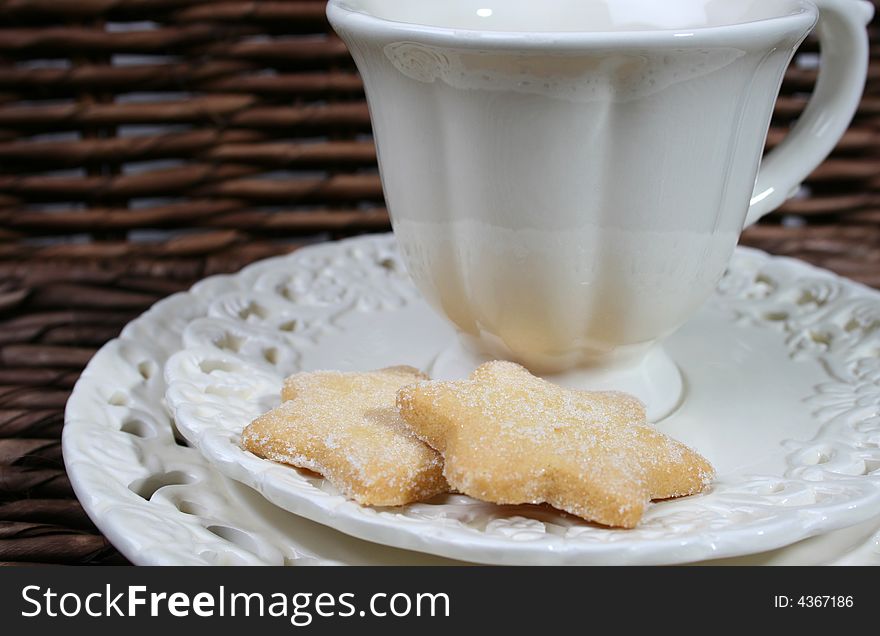 Cup and saucer with star shaped biscuits. Cup and saucer with star shaped biscuits