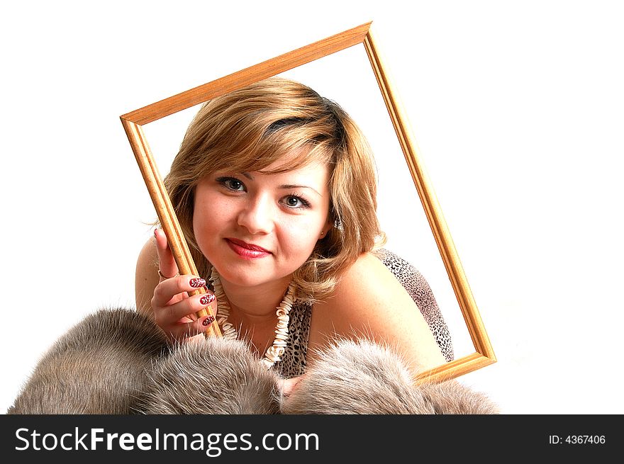 Woman laying on fur and holding a frame over her face. Woman laying on fur and holding a frame over her face