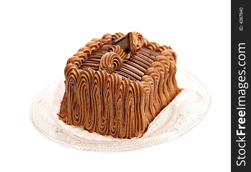 A beautifully decorated chocolate cake torte with a square of chocolate on top.