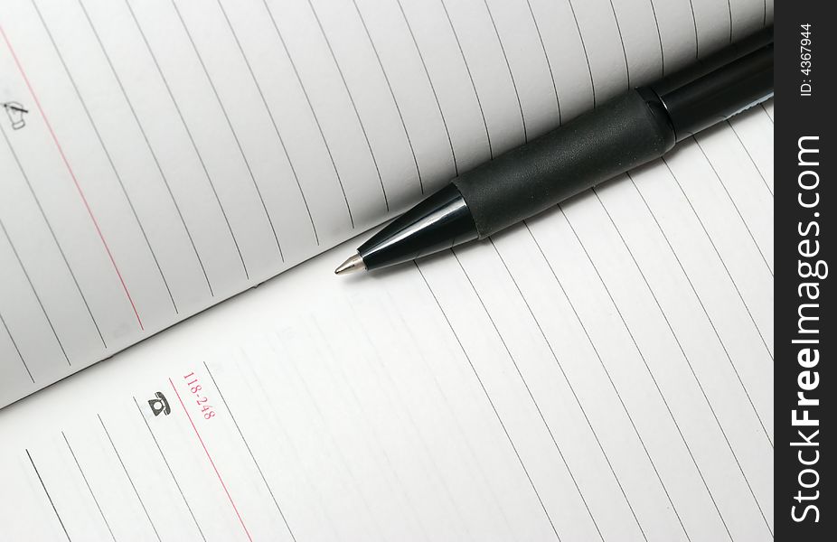 Jotter and pen. The Notebook with a black ball pen. Jotter and pen. The Notebook with a black ball pen