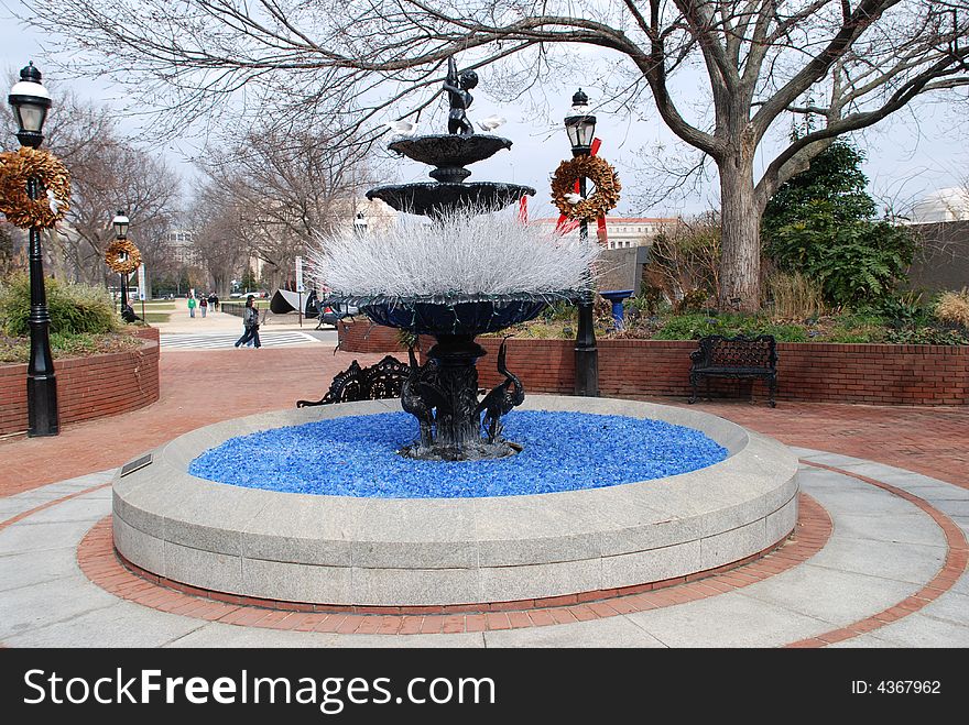 A winter fountain without water. Water in pool is simulated with stones. A winter fountain without water. Water in pool is simulated with stones.