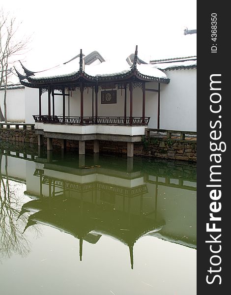 This picture is taken in Zhuozheng park in Suzhou ,China.A pavilion decoated with snow and their reflection in the water. This picture is taken in Zhuozheng park in Suzhou ,China.A pavilion decoated with snow and their reflection in the water.