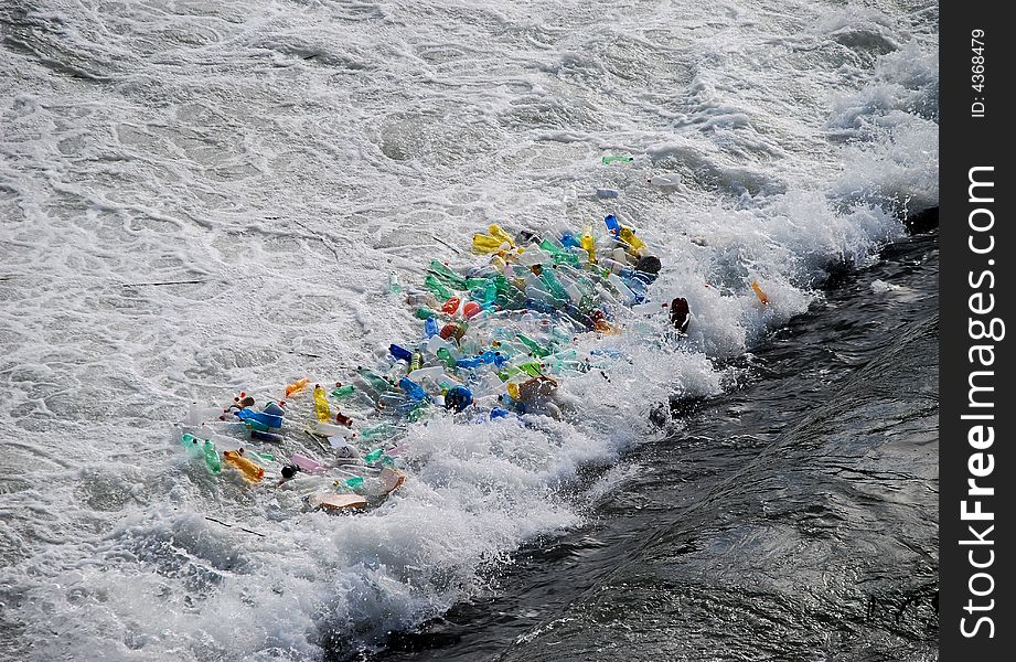 Plastic bottles trapped in the foam at the base of a waterfall.  Taken on the Tiber River in Rome, Italy. Plastic bottles trapped in the foam at the base of a waterfall.  Taken on the Tiber River in Rome, Italy.