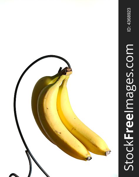 Bananas hanging in a bunch on white isolated background. Bananas hanging in a bunch on white isolated background.