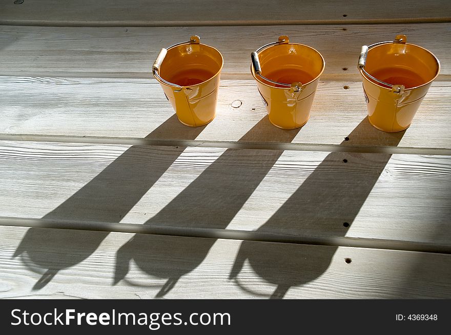 Orange utensils, shadow on a floor. Orange utensils, shadow on a floor.