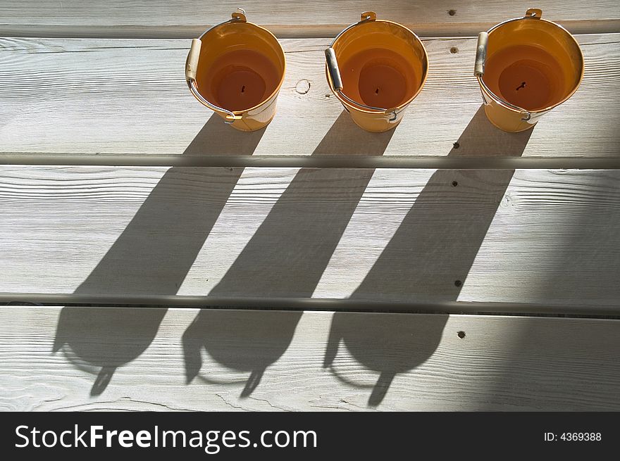 Orange utensils, shadow on a floor. Orange utensils, shadow on a floor.