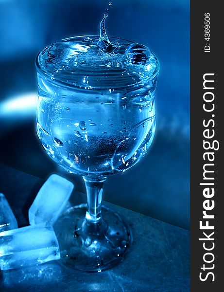 Installation with goblet of water and ice on blue background. Installation with goblet of water and ice on blue background
