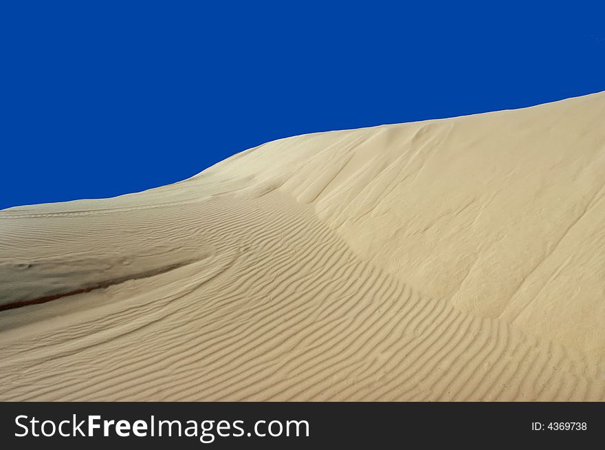 Sand Dune With Blue Sky Background