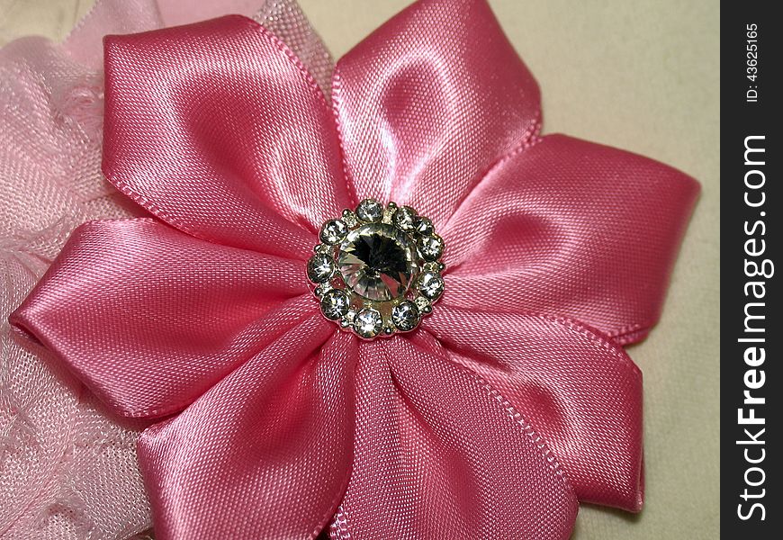 Satin pink flower with brooch with faux rhinestone