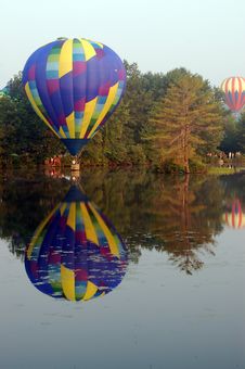Hot Air Balloon Touching The Water Stock Photos