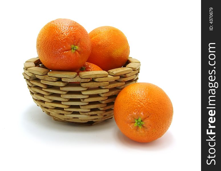 Oranges in wooden bowl on a white background