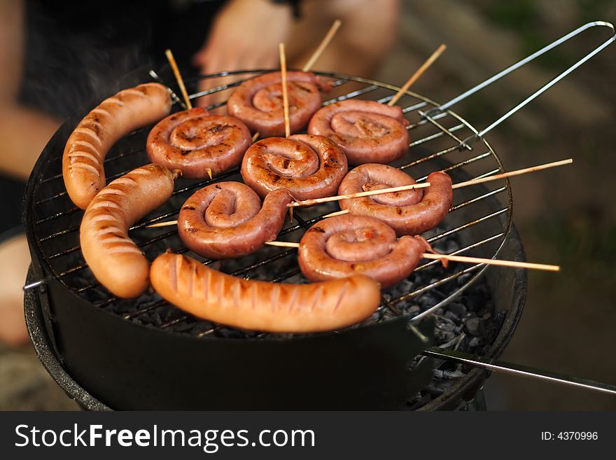Rolled sausage and pork chops in the grill. Rolled sausage and pork chops in the grill