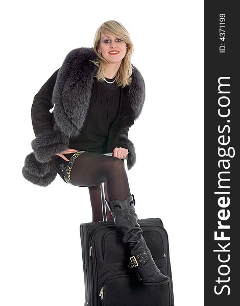 Beautiful blonde with valise on black background