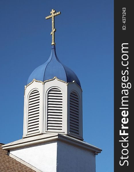 A Church steeple against a blue sky