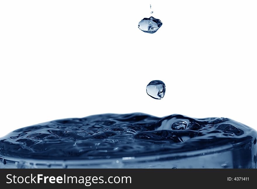 Isolated blue drops are falling down and impact with liquid surface. Isolated blue drops are falling down and impact with liquid surface