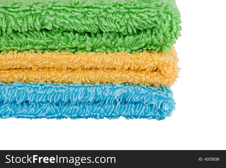 Towels of different colors on white background
