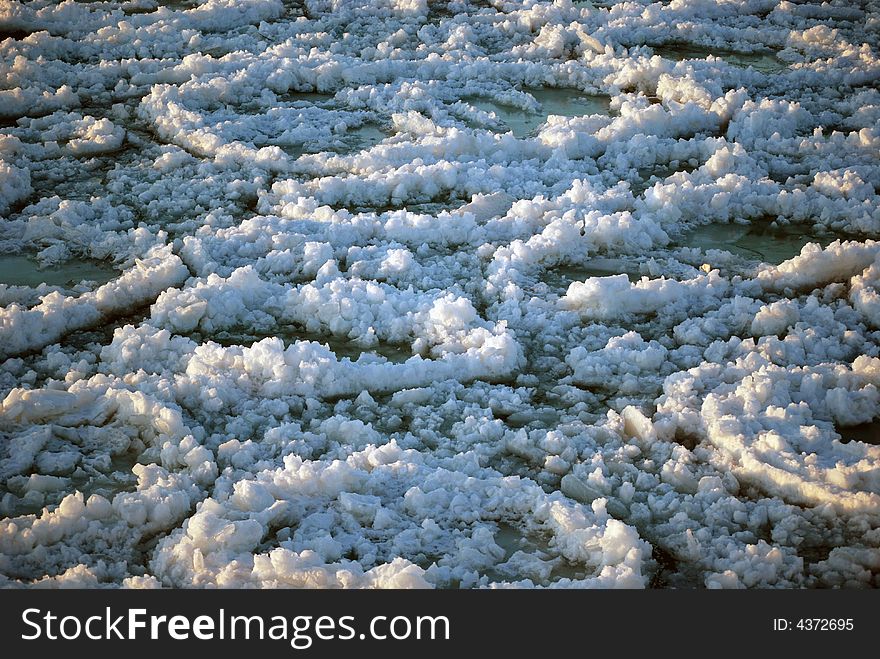 Circular formations of ice on the lake caused by water current. Circular formations of ice on the lake caused by water current.