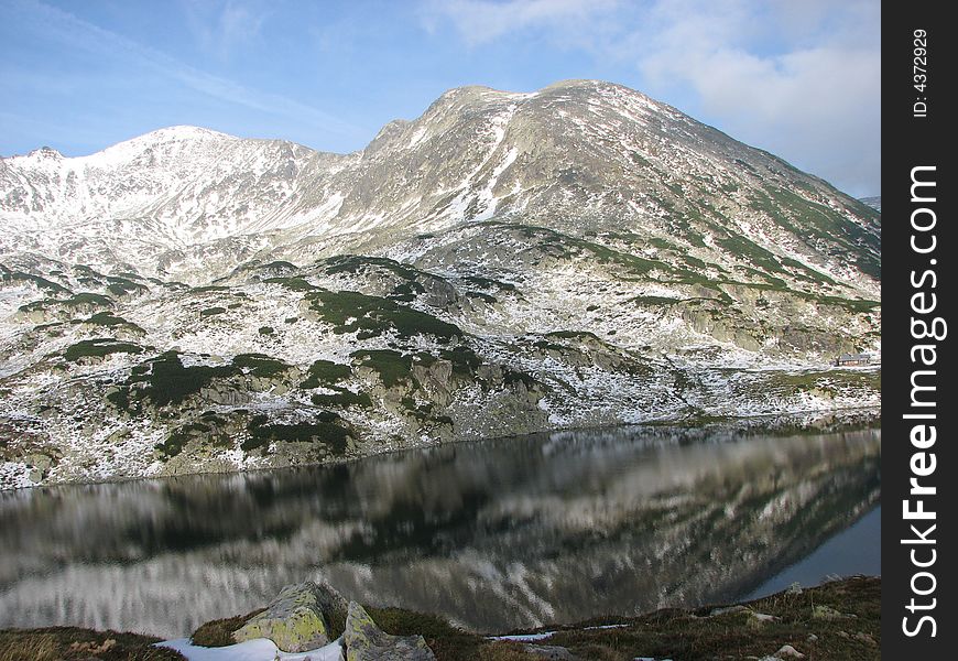 A mountain mirrored in a lake. A mountain mirrored in a lake
