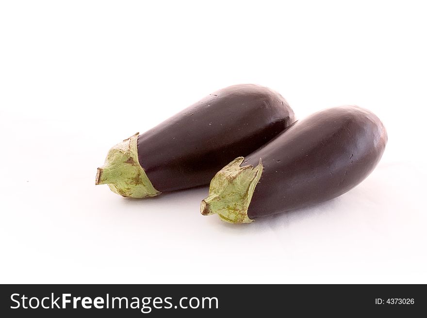 Two eggplants lying together on white. Two eggplants lying together on white