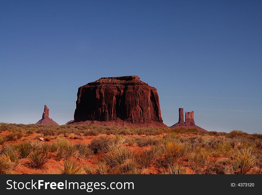 View of the red rock formations in Monument Valley with blue skyï¿½s