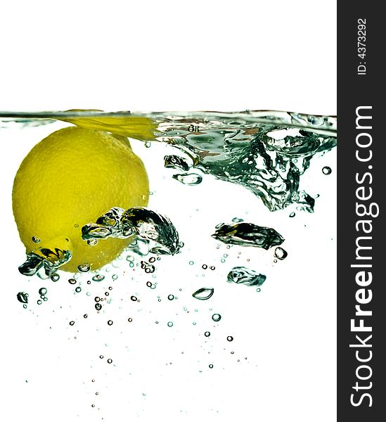 Lemon falling in water close-up