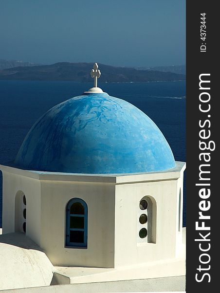 Blue domed church overlooking the sea in Santorini