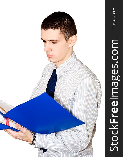 The young man in a striped shirt reads documents in a  blue folder. The young man in a striped shirt reads documents in a  blue folder