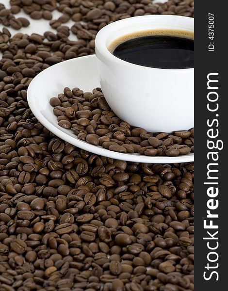 Cup of coffee and coffee beans background. Cup of coffee and coffee beans background