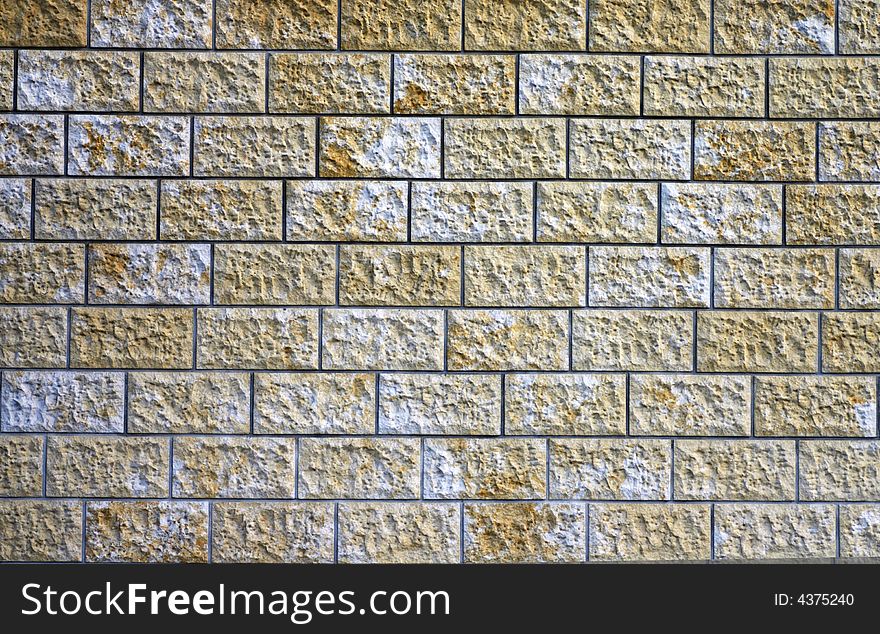 The granite stone blocks wall.