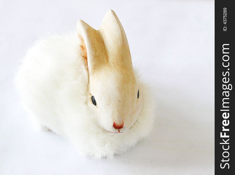 Little white easter rabbit on gray background. easter decoration