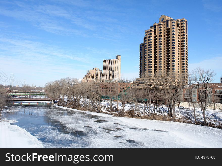 A picture of an icy landscape with high towers and frozen river water. A picture of an icy landscape with high towers and frozen river water