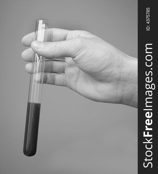 Hand holding a tube - B&W image - it can represent historical medicine or science. Hand holding a tube - B&W image - it can represent historical medicine or science...