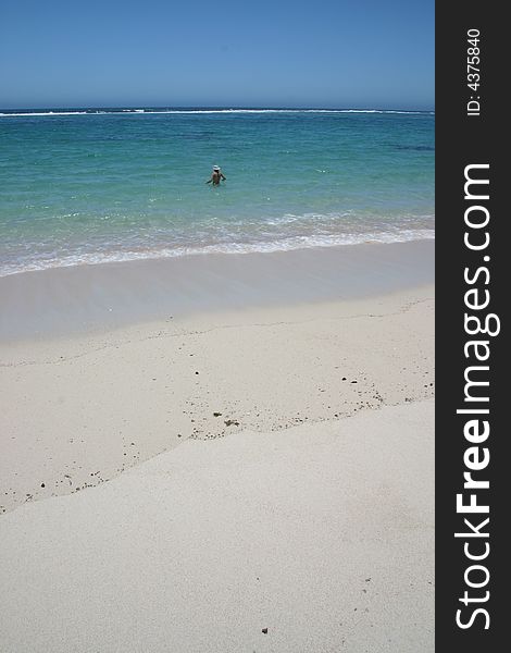 Beautiful view at sandy beach with one woman going to swim in a turquoise clear water. Australia. Beautiful view at sandy beach with one woman going to swim in a turquoise clear water. Australia.