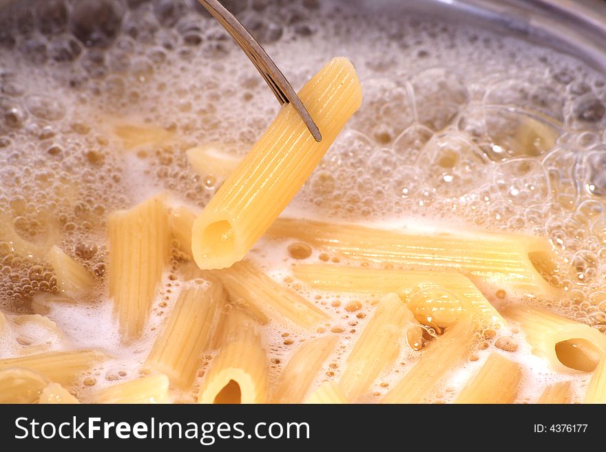 Penne pasta draining - in kitchen