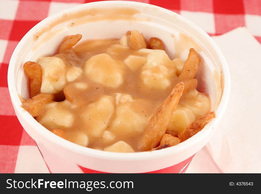 French fries smothered in gravy and melted cheese, also known as poutine