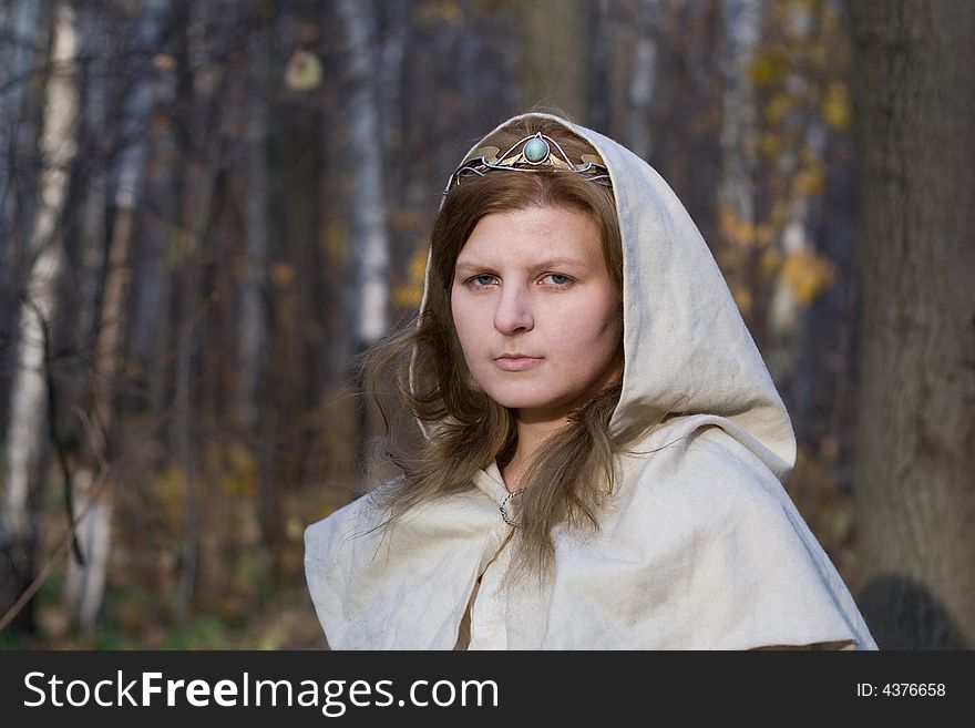 Portrait of the romantic girl in autumn forest. Portrait of the romantic girl in autumn forest