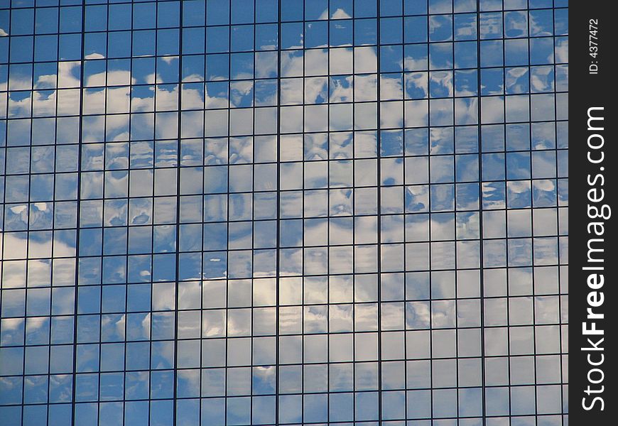 Clouds reflecting off of a building's windows. Clouds reflecting off of a building's windows.