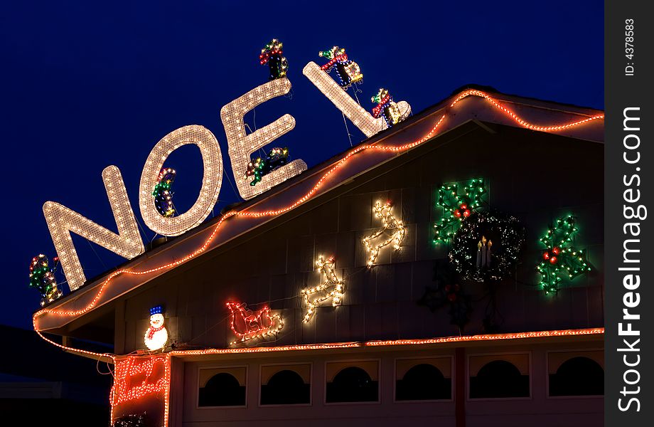 Christmas decorated house with Noel sign