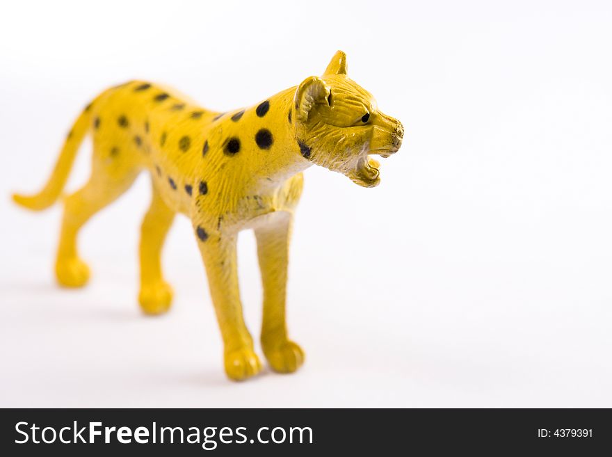 Single leopard figure toy macro white background. Single leopard figure toy macro white background