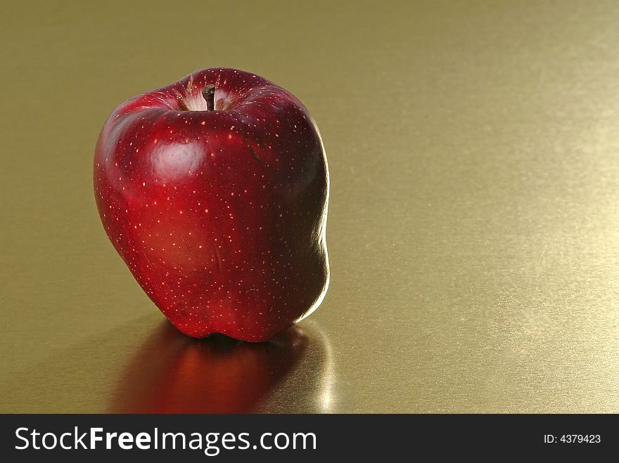 Red apple with golden background