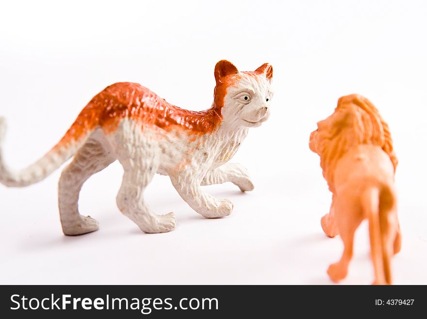 Cat and lion figure toy macro on thw white background
