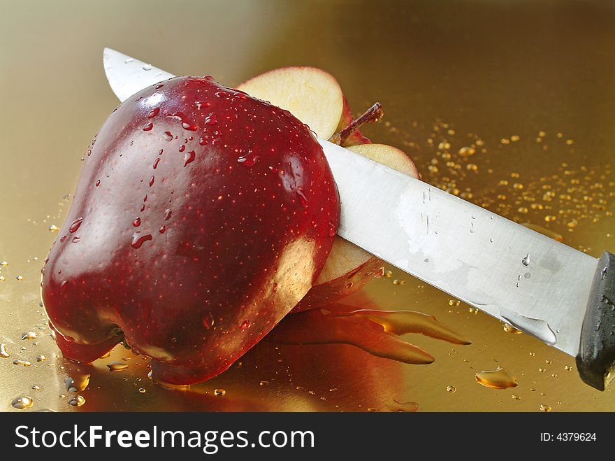 Red apple with golden background