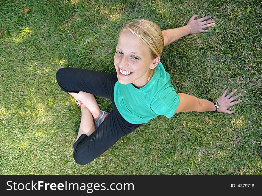 Athletic young woman relaxing duruing a break in her workout. Athletic young woman relaxing duruing a break in her workout