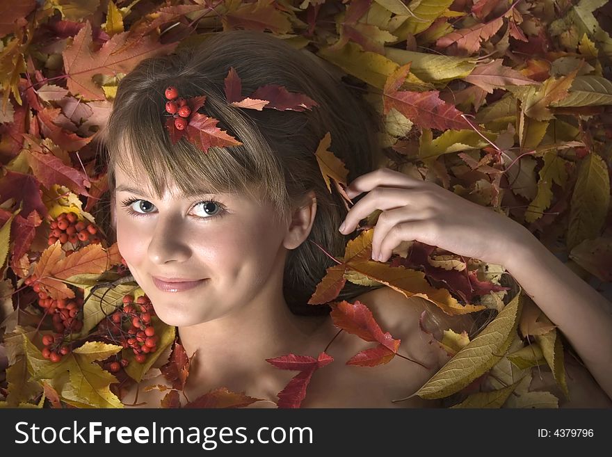 Portrait of a beautiful young girl in autumn leaves. Portrait of a beautiful young girl in autumn leaves